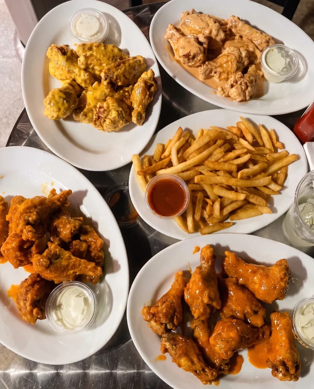 Plates of wings and fries on a table at Blue 42